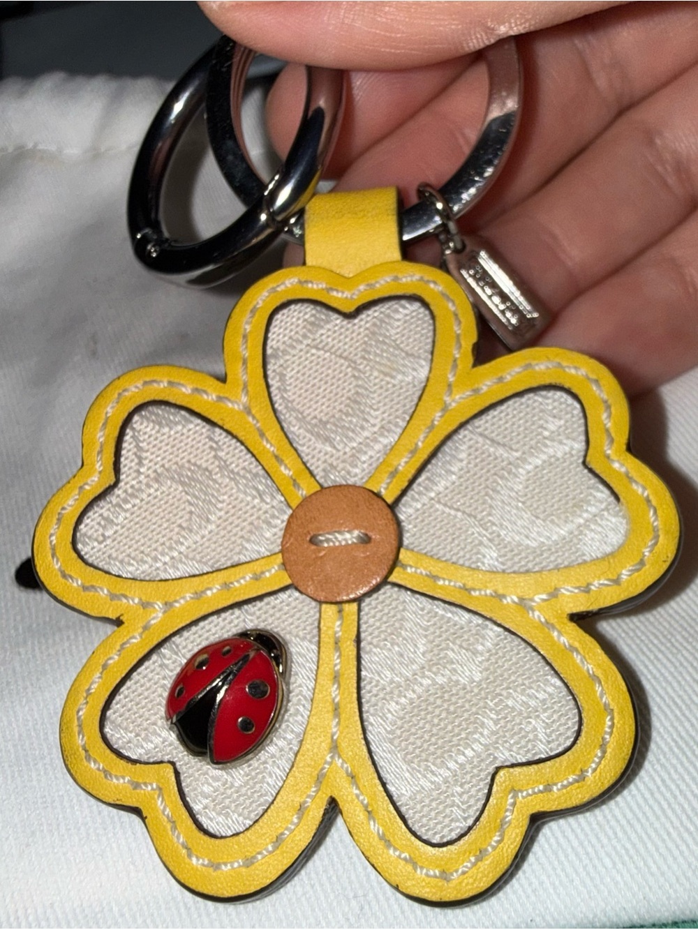Yellow coach lady bug charm